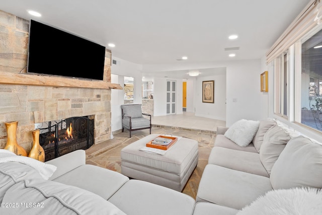 living room with recessed lighting, visible vents, and a fireplace