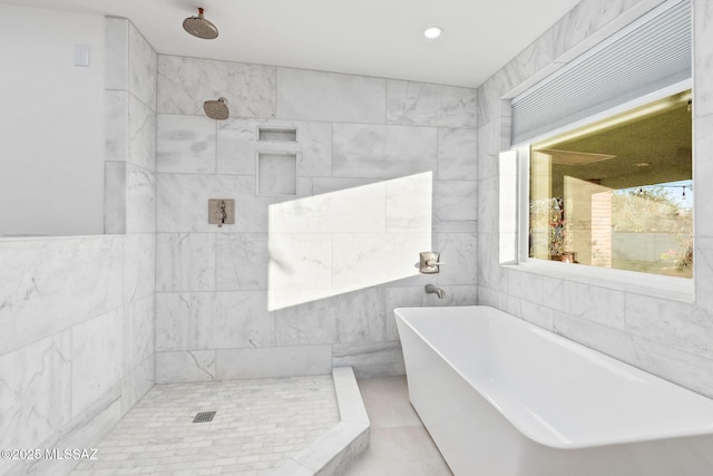 full bathroom featuring recessed lighting, a soaking tub, a tile shower, and tile walls