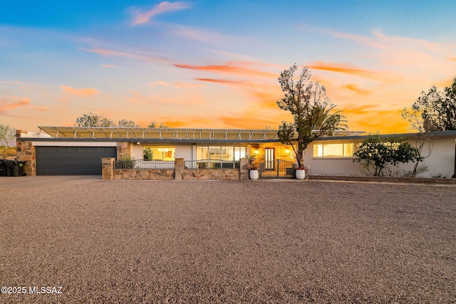 view of front of property featuring a garage, concrete driveway, and stucco siding