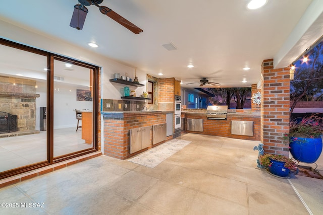 view of patio / terrace featuring visible vents, a grill, an outdoor kitchen, and ceiling fan