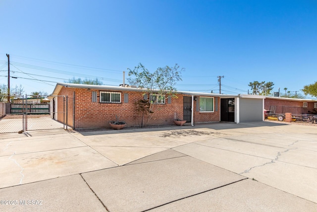 single story home with brick siding, fence, and a gate