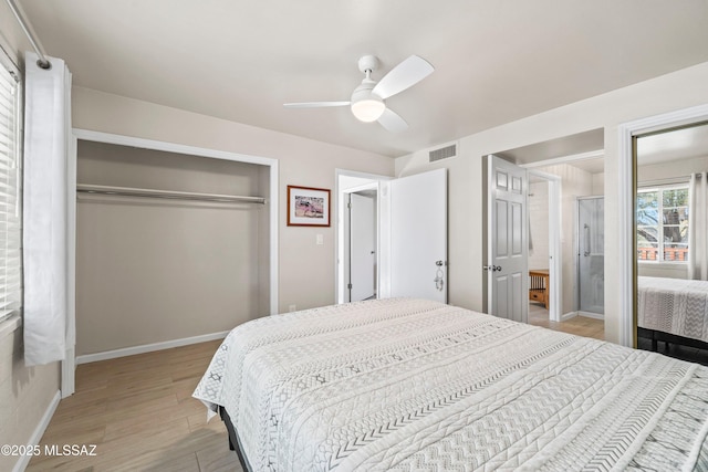 bedroom with a ceiling fan, visible vents, baseboards, a closet, and light wood-type flooring