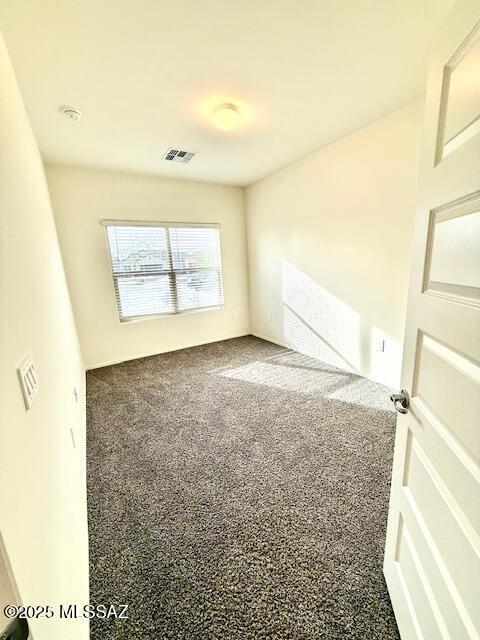 empty room with carpet and visible vents