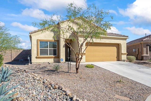 view of front facade featuring driveway, a tiled roof, fence, and stucco siding