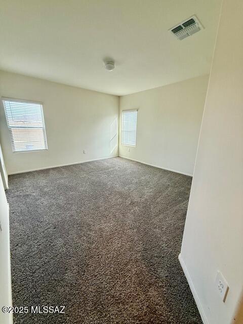 spare room with carpet and visible vents