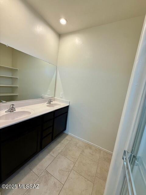 full bathroom featuring double vanity, recessed lighting, a sink, and tile patterned floors