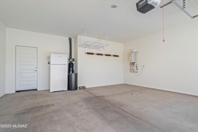 garage with water heater, a garage door opener, and freestanding refrigerator