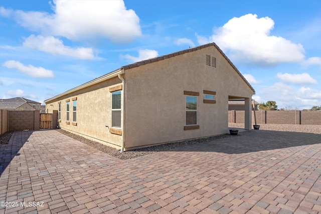 back of property featuring a patio area, a fenced backyard, and stucco siding