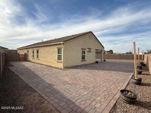 back of property featuring a patio area, a fenced backyard, and stucco siding