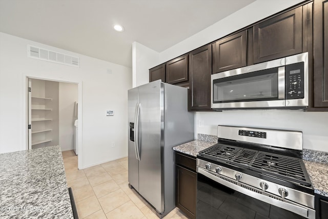 kitchen with light stone counters, light tile patterned floors, visible vents, appliances with stainless steel finishes, and dark brown cabinets