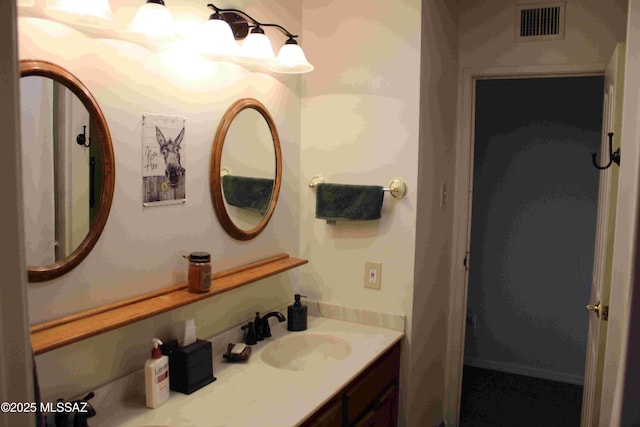 bathroom featuring visible vents and vanity