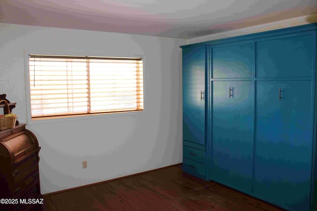 bedroom with a closet and wood finished floors