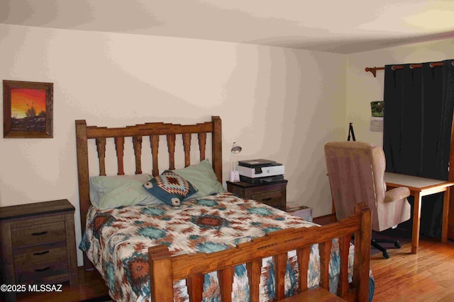 bedroom featuring wood finished floors