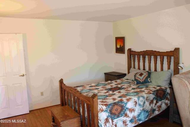 bedroom featuring wood finished floors