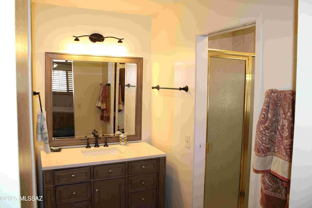 bathroom with a shower stall and vanity