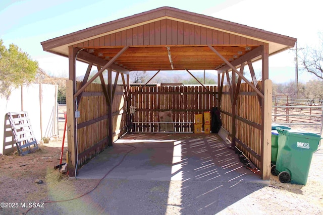 view of patio / terrace featuring fence and a detached carport