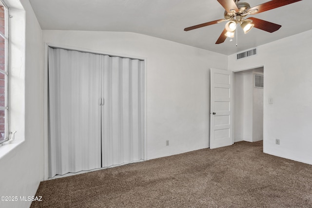 unfurnished bedroom with ceiling fan, a closet, carpet flooring, and visible vents