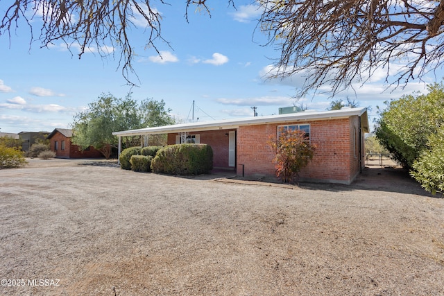 single story home featuring brick siding