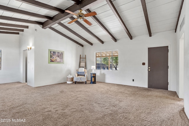 unfurnished room with high vaulted ceiling, beamed ceiling, carpet flooring, and a ceiling fan