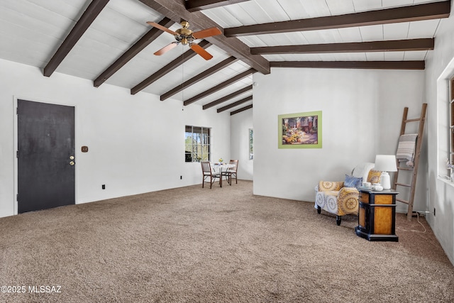 unfurnished room with vaulted ceiling with beams, ceiling fan, and carpet flooring