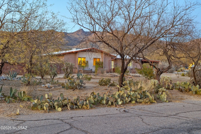 mid-century home with a mountain view and brick siding