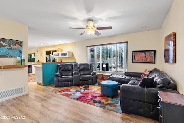 living area featuring light wood-style flooring, visible vents, a ceiling fan, and recessed lighting