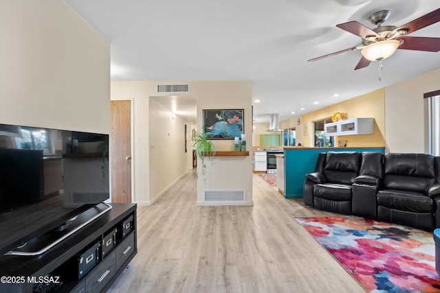 living room featuring light wood-type flooring, baseboards, visible vents, and recessed lighting