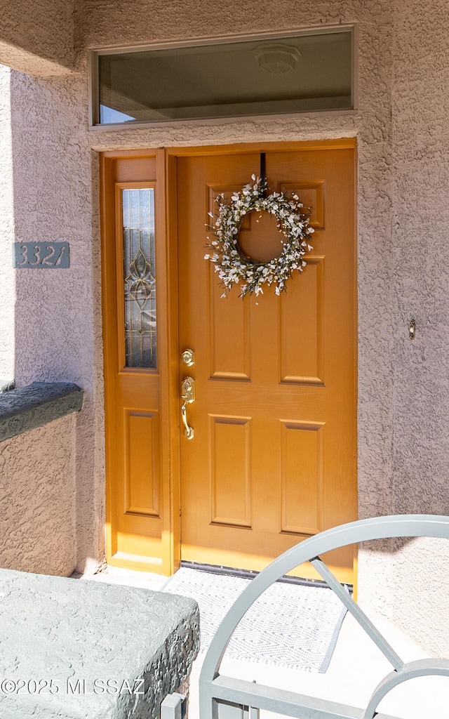 view of exterior entry featuring stucco siding