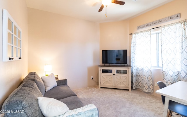 carpeted living area featuring a ceiling fan