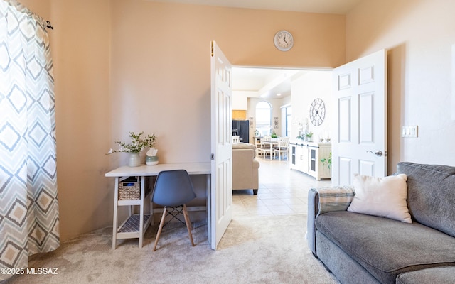 home office featuring light carpet and light tile patterned floors