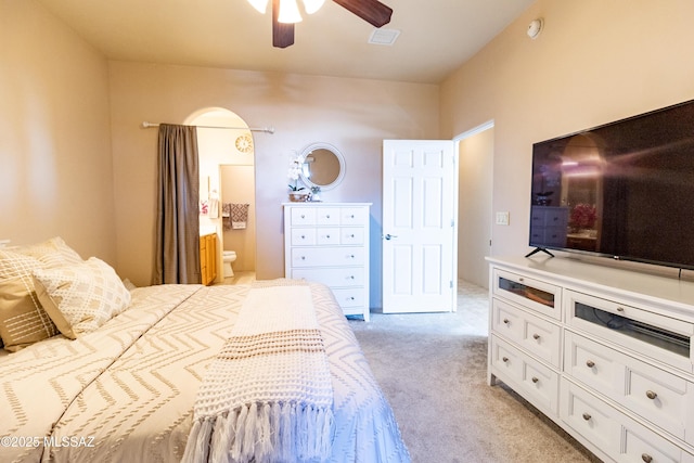 bedroom with light carpet, ceiling fan, and ensuite bathroom