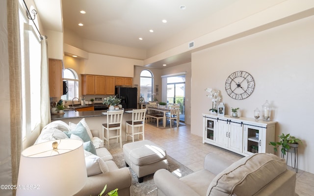 living area featuring recessed lighting, visible vents, and light tile patterned floors