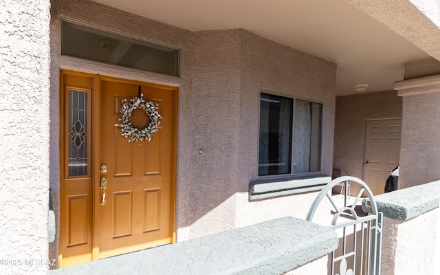 property entrance featuring stucco siding