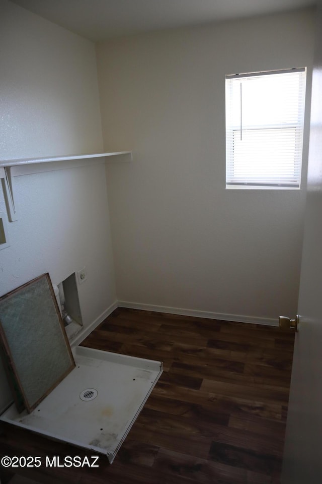 empty room featuring dark wood-style floors and baseboards