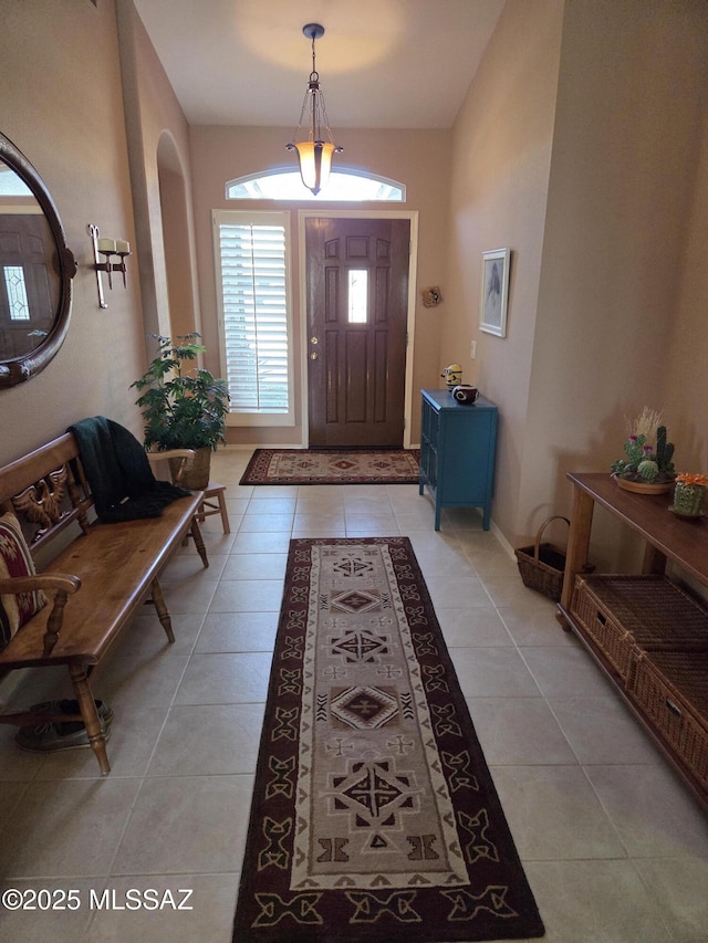 entryway featuring baseboards and light tile patterned floors