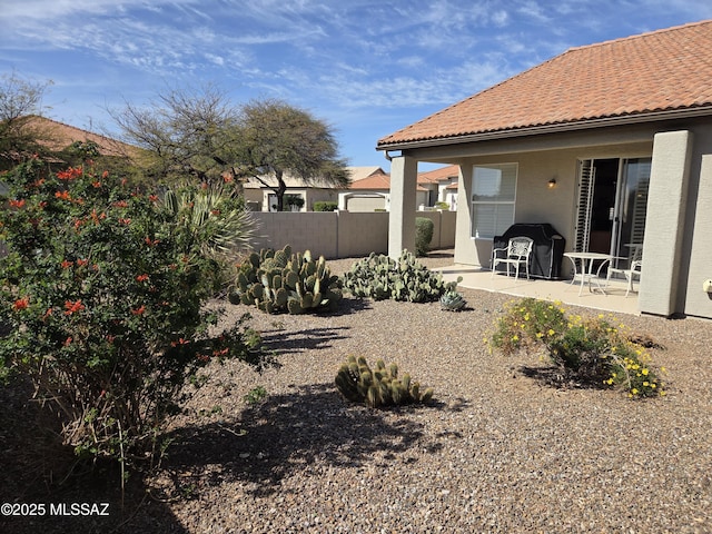 view of yard with fence and a patio