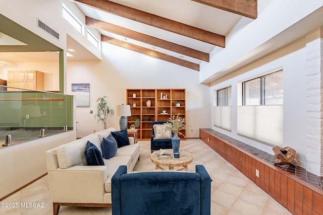 living room featuring high vaulted ceiling, beam ceiling, visible vents, and baseboards