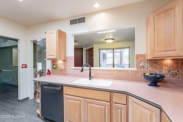 kitchen with visible vents, decorative backsplash, dishwasher, light brown cabinets, and a sink