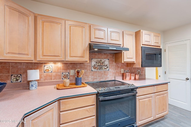 kitchen with black appliances, under cabinet range hood, backsplash, and light brown cabinetry