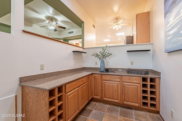 bar featuring ceiling fan, visible vents, and freestanding refrigerator