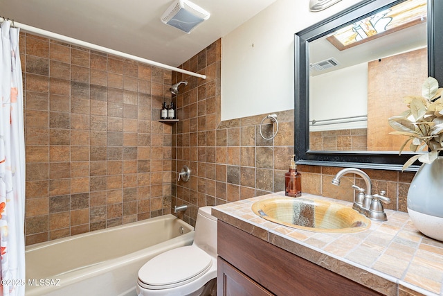 bathroom with shower / tub combo with curtain, tile walls, visible vents, toilet, and vanity