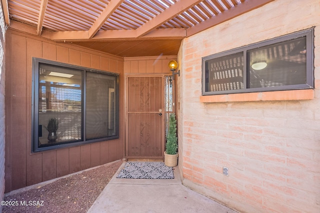 property entrance featuring a pergola