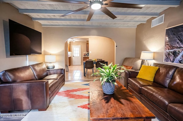 living room featuring arched walkways, wooden ceiling, visible vents, and beamed ceiling