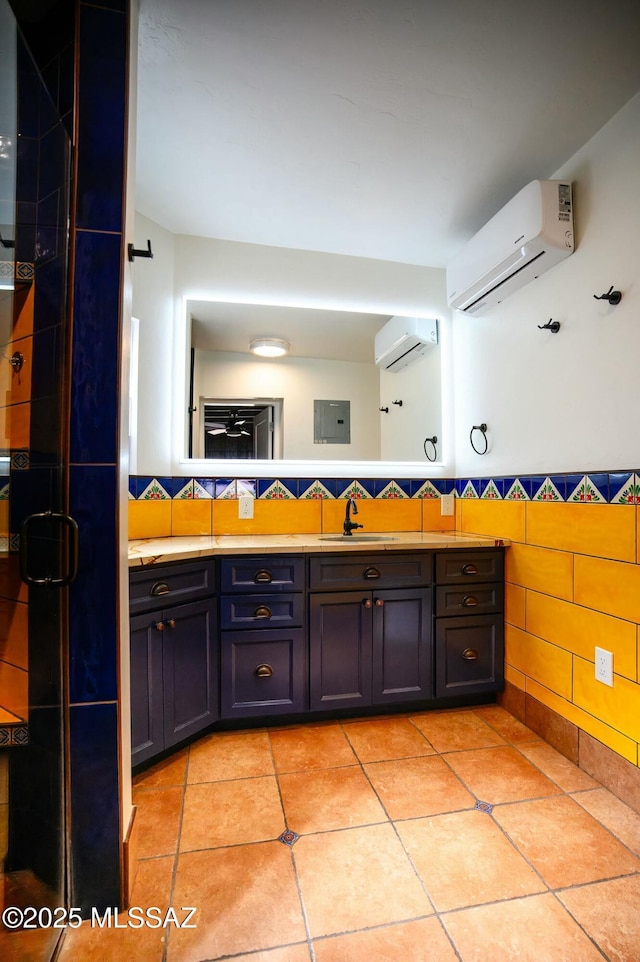 bathroom with an AC wall unit, wainscoting, vanity, and tile walls