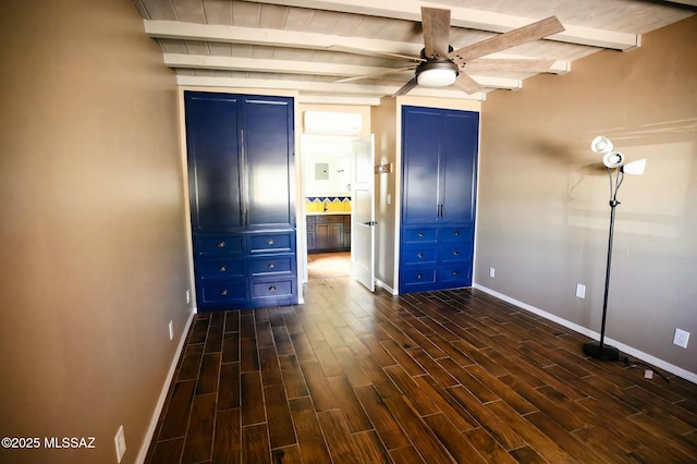 unfurnished bedroom featuring dark wood-style floors, beam ceiling, and baseboards