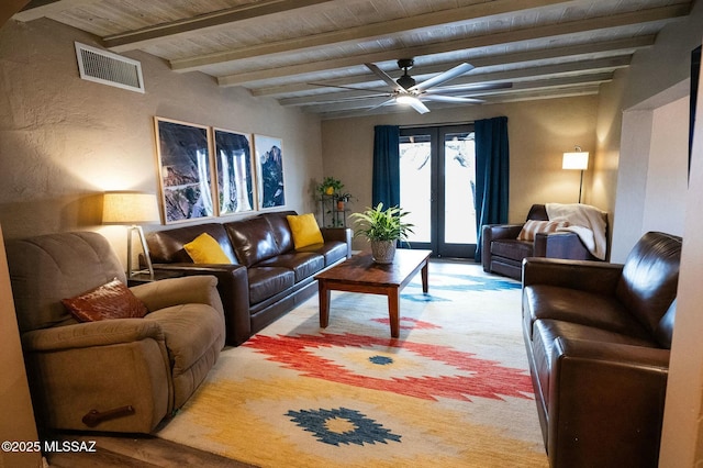 living area with wooden ceiling, visible vents, beamed ceiling, and french doors