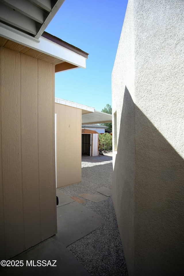 view of side of home with a patio area and an outdoor structure