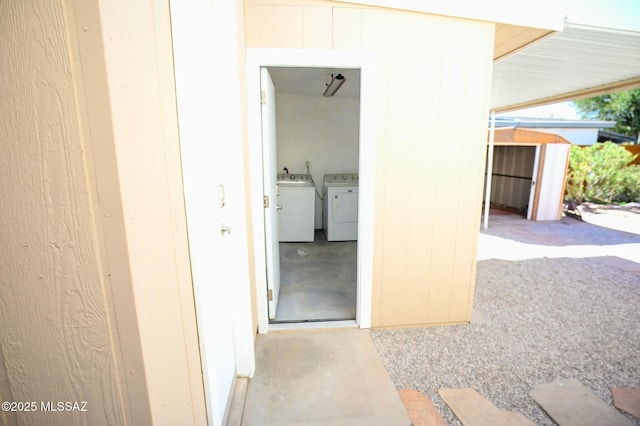 property entrance featuring independent washer and dryer and a sink