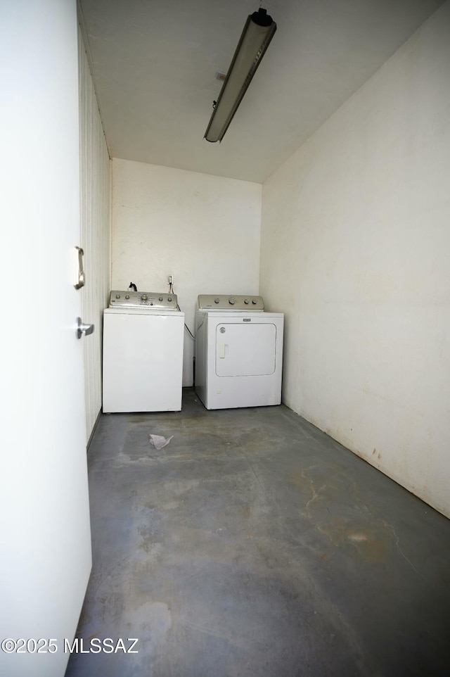 clothes washing area featuring washer and dryer and laundry area