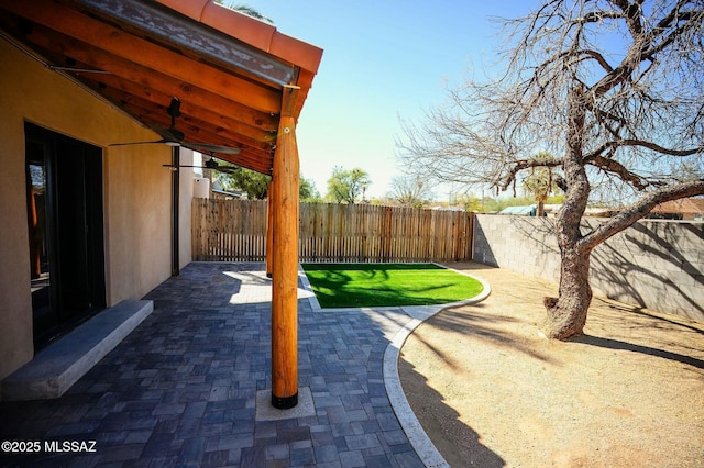 view of patio with ceiling fan and a fenced backyard